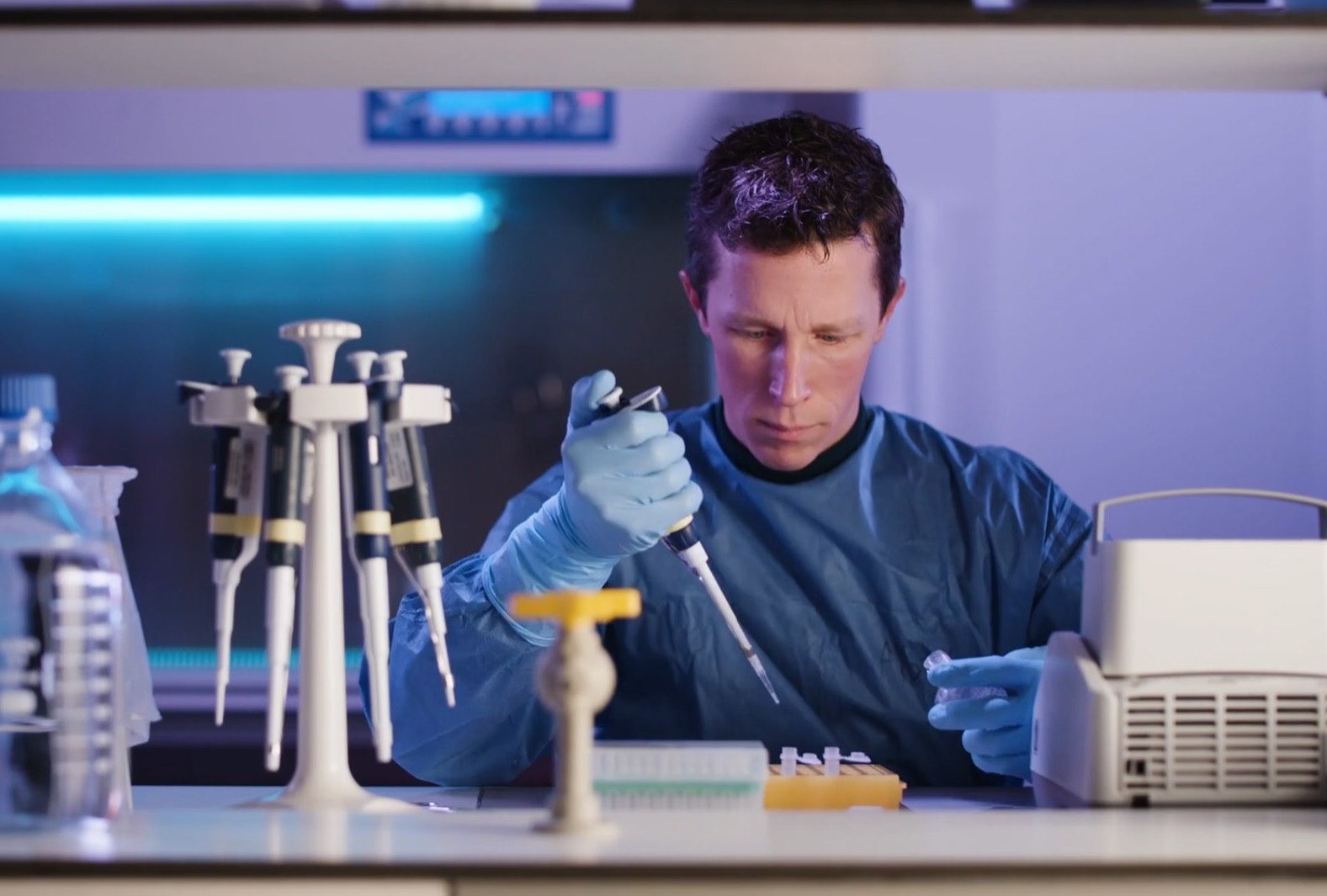 Researcher in the lab with purple hue.jpg