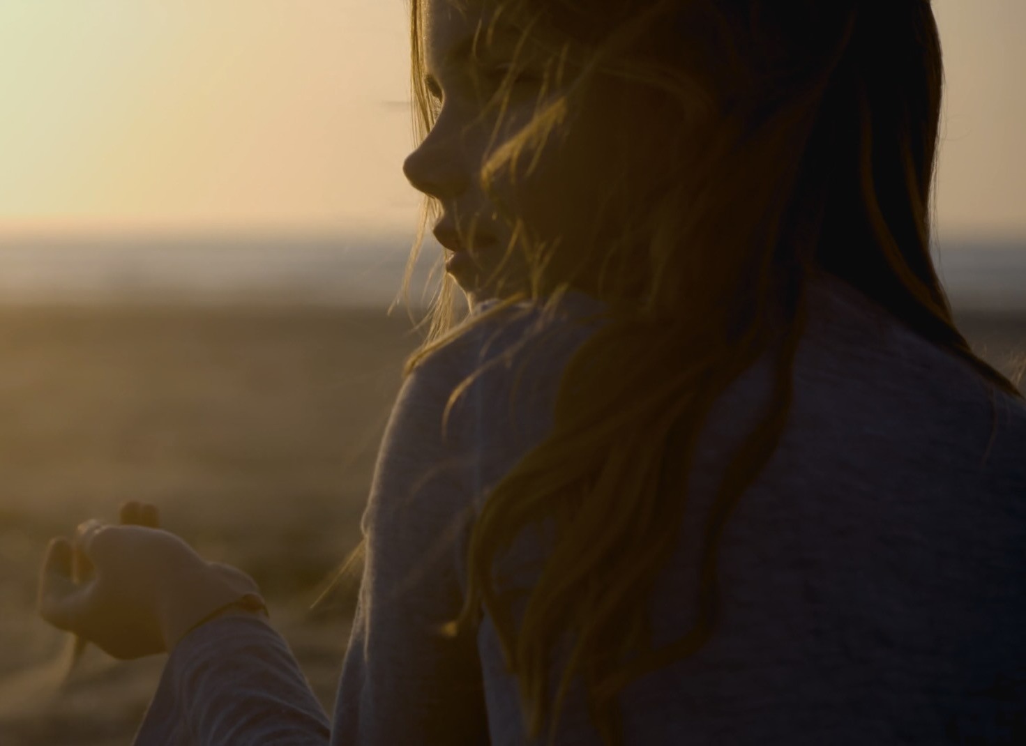 girl sitting on the beach in profile.jpg