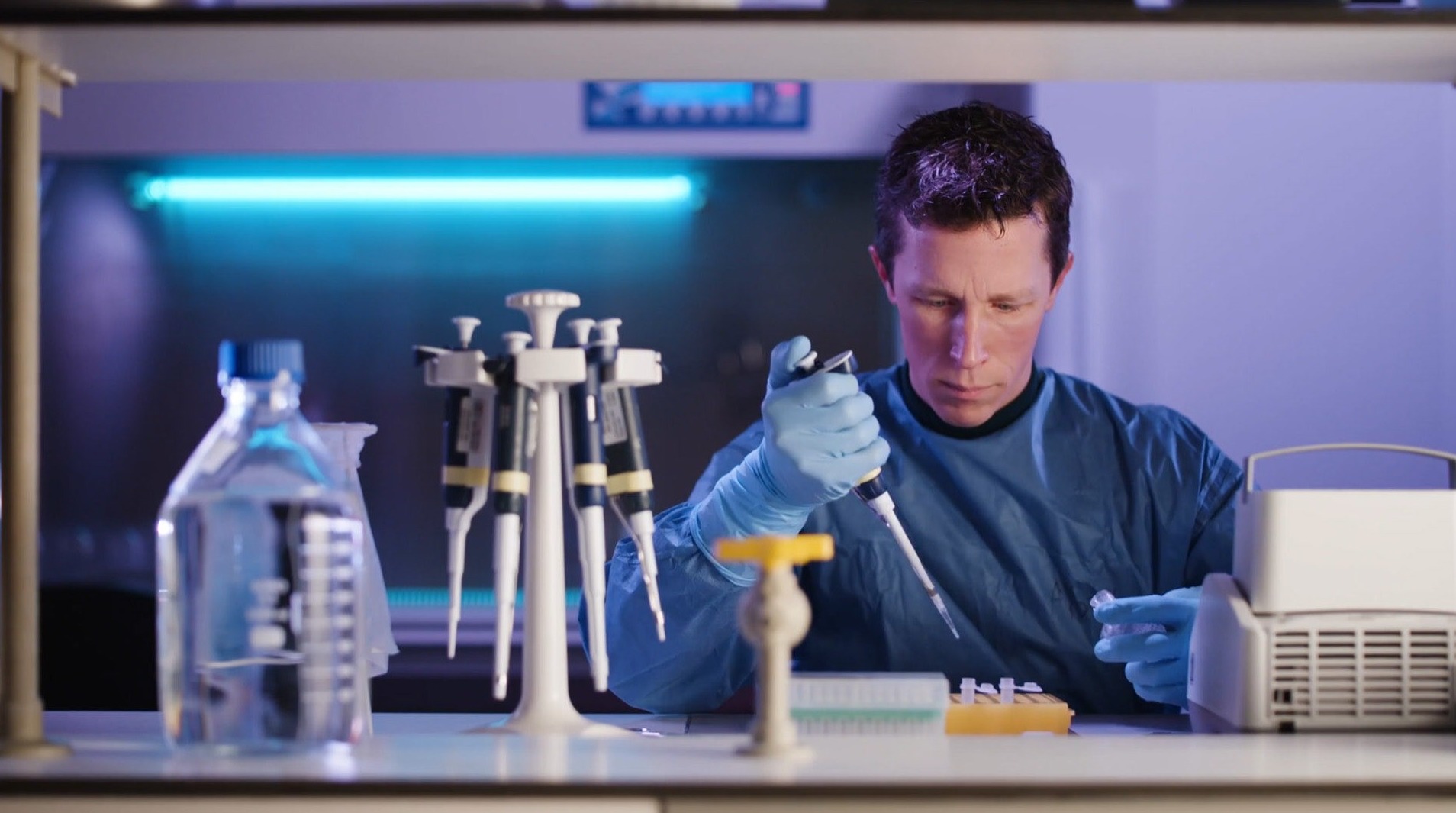 Researcher in the lab with purple hue.jpg