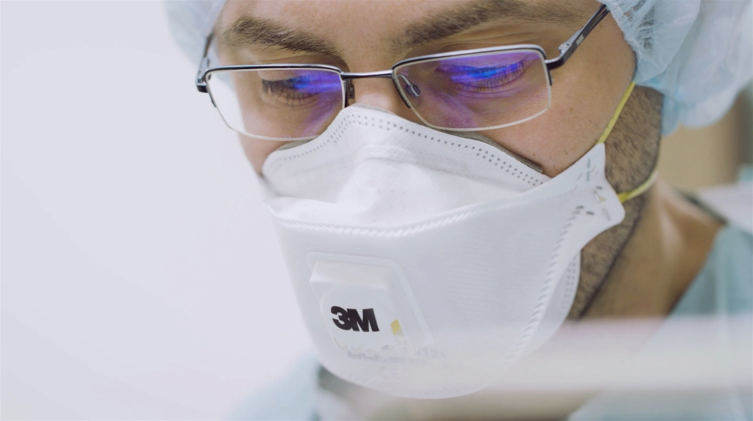 Researcher with glasses at work in biosafety laboratory.jpg